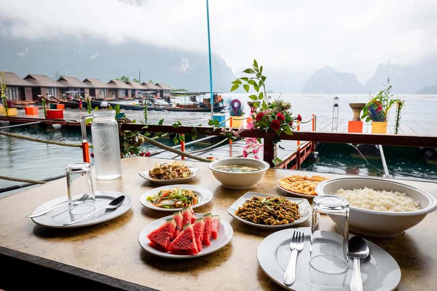 From Krabi: Cheow Lan Lake Cruise and Khao Sok Jungle Hike - Coral Cave: stalagmites, stalactites, and that narrow-feeling moment